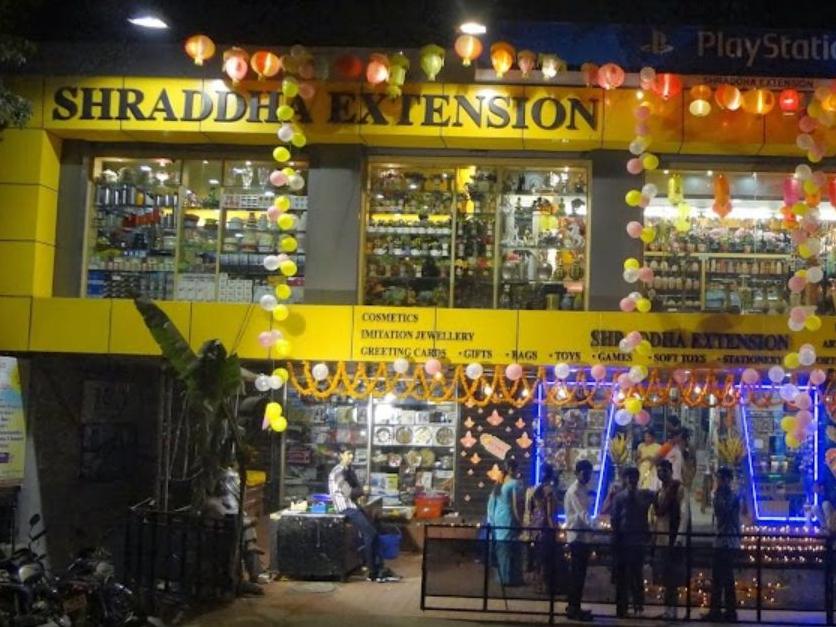 Shraddha Extension Secunderabad store front at night, decorated with lanterns and balloons